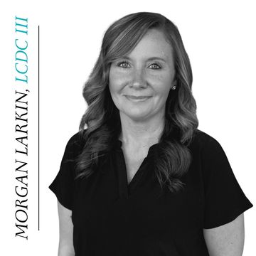 Portrait of Morgan Larkin with styled hair and a black blouse.