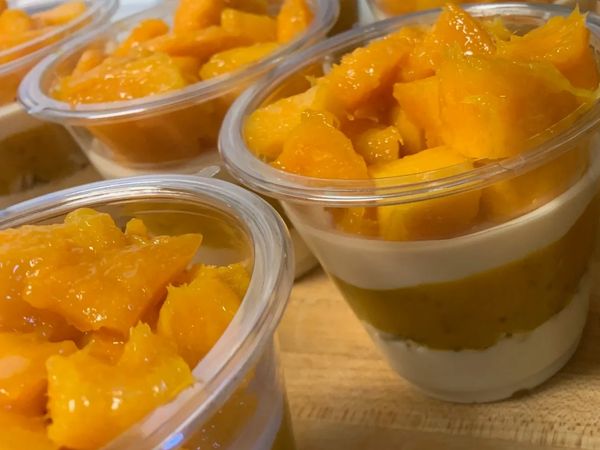 Mango Turmeric Flavour Coconut-Cashew Yogurt Parfait (layered yogurt cup with mango on top)