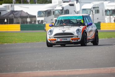 Mini Cooper race car on a racetrack.