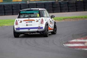 White race car turning on track.
