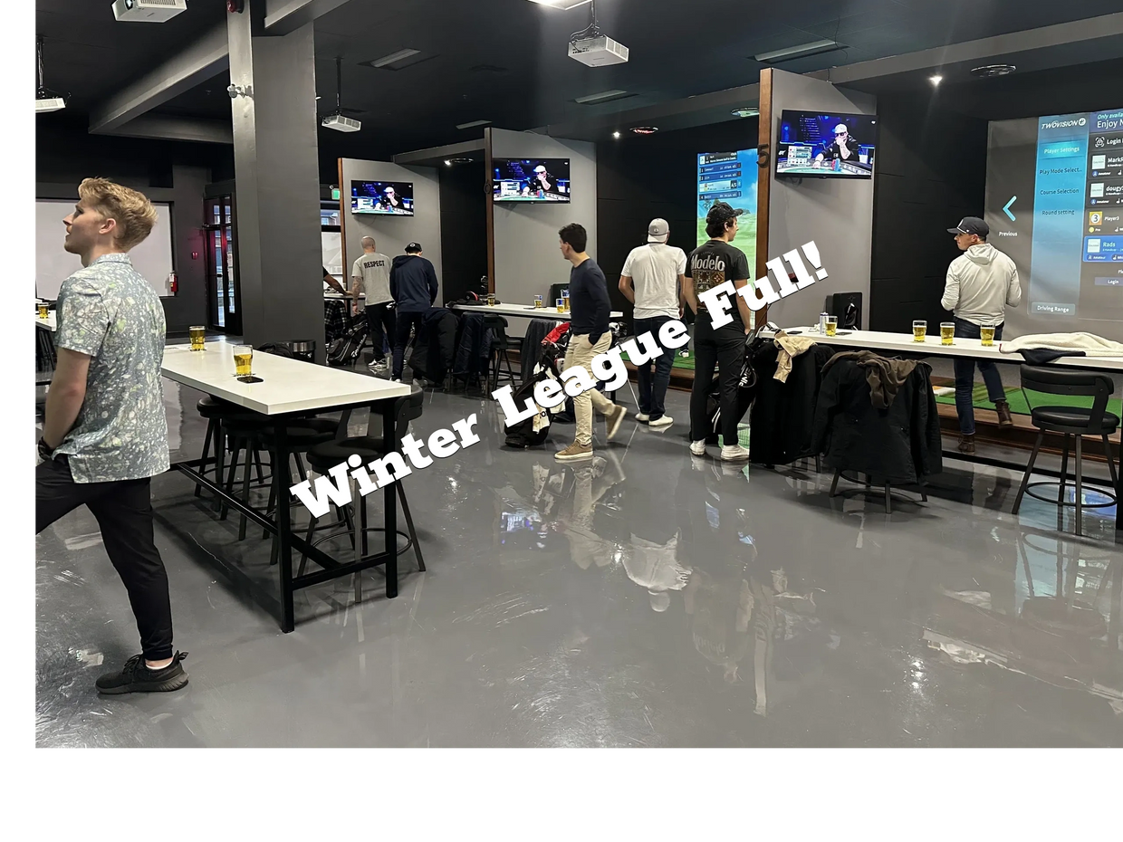 People enjoying a golf simulation lounge with drinks and screens.
