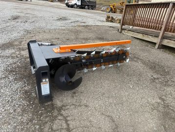 Heavy-duty trencher attachment for excavation machinery.