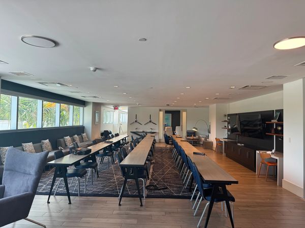 Modern conference room with long tables and chairs.