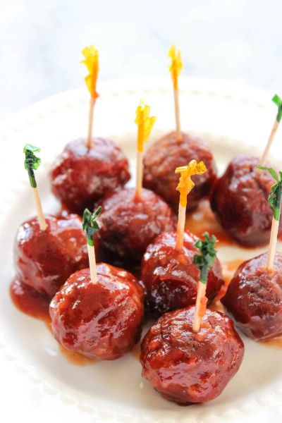 Barbecue glazed meatballs on a plate with toothpicks.