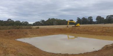 Excavator creating a dam 