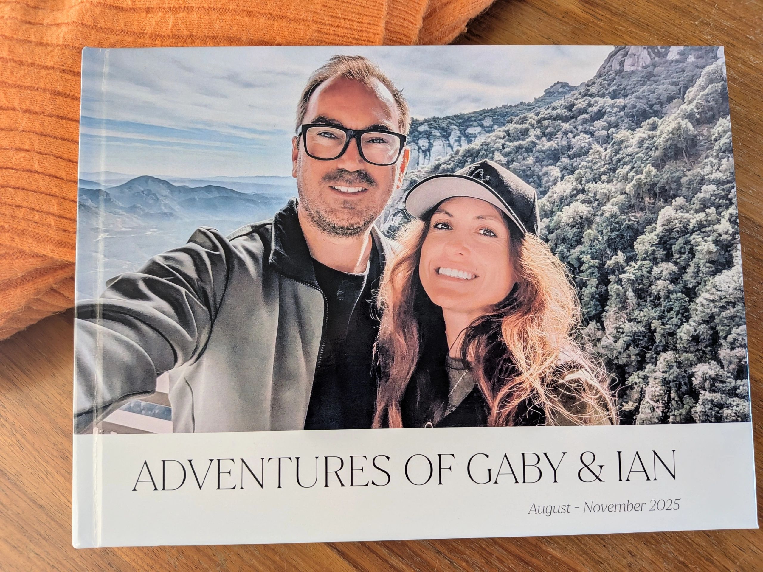 Photo book cover showing a smiling couple with mountains in the background.