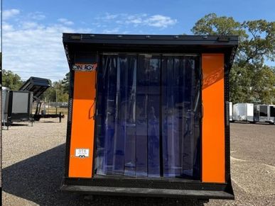 Small orange and black portable shelter with clear plastic strip door.