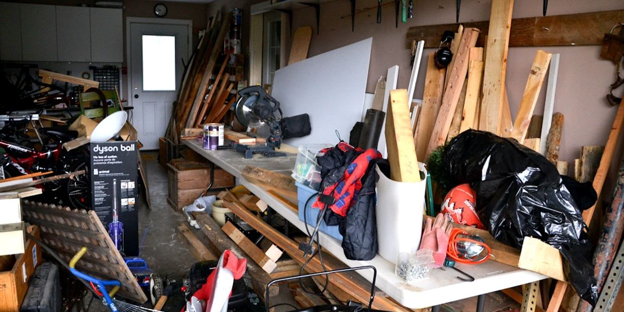 garage with random items including wood, tools, boxes
