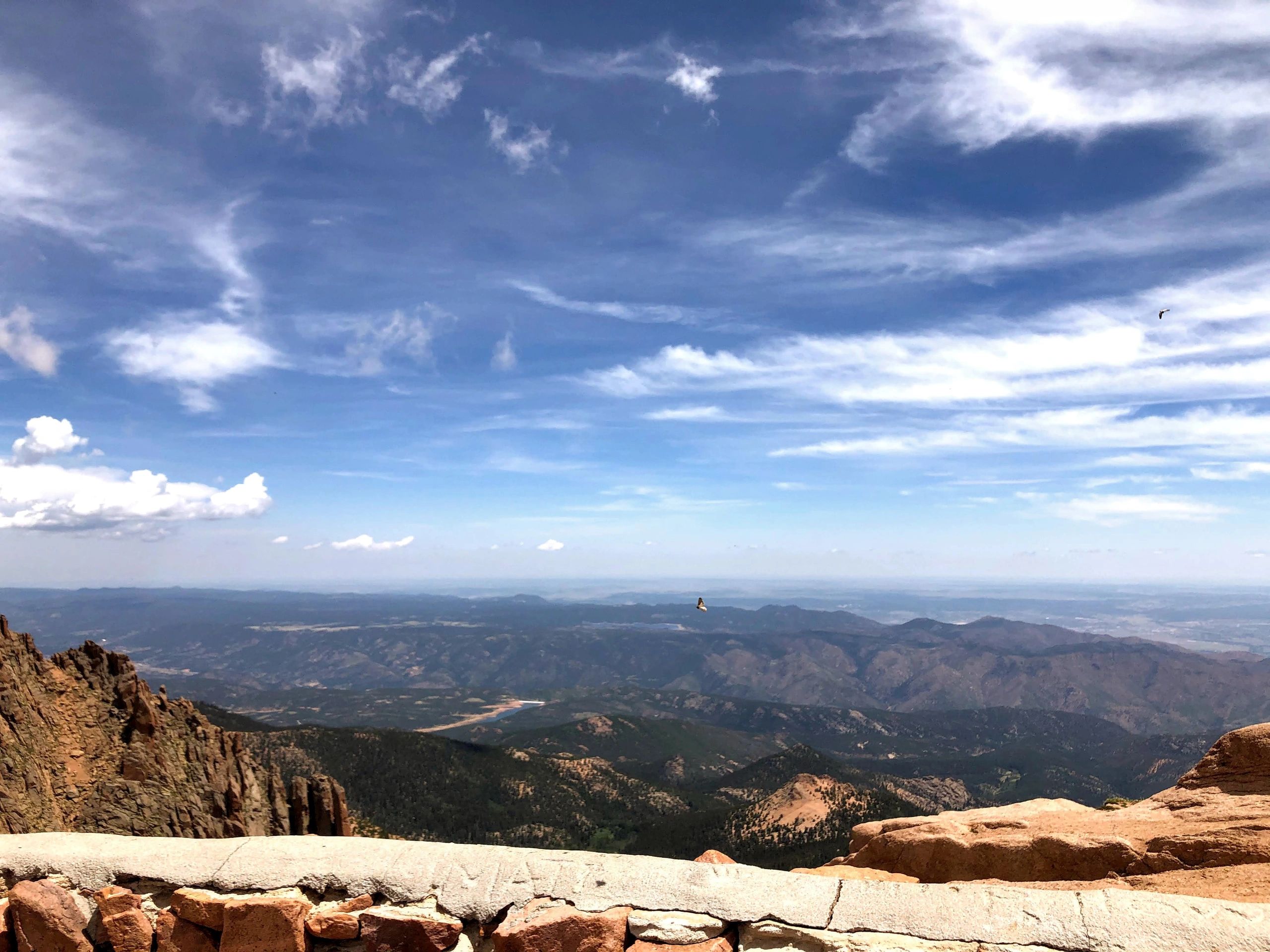 Mountain view with blue sky and scattered clouds.