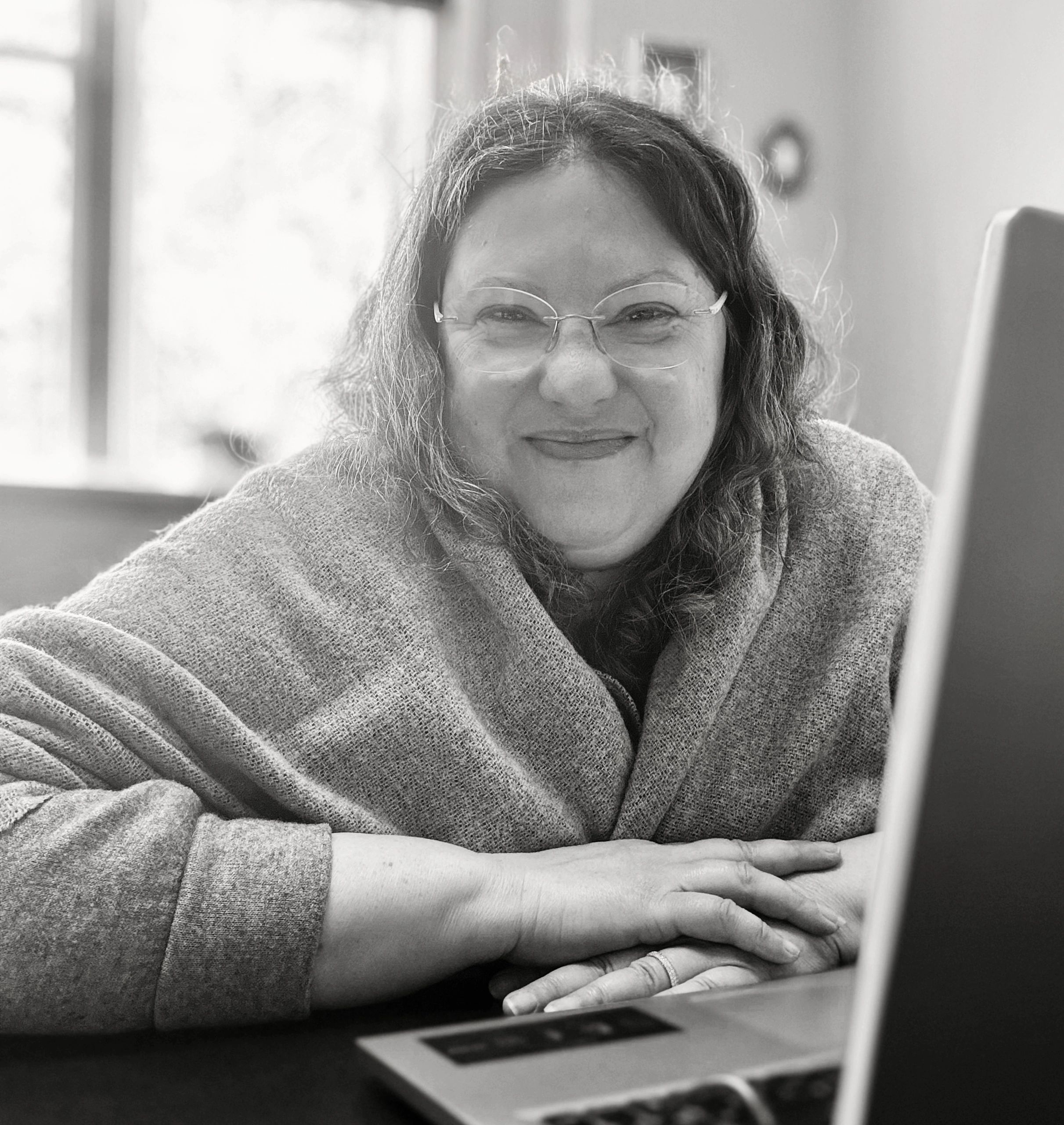 Image of Daniela Siggia-Beasant sitting at a desk in 2025 @Black Ram Media Group Inc