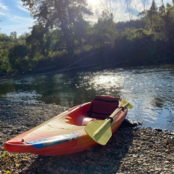 Kayak sitting on the river’s edge