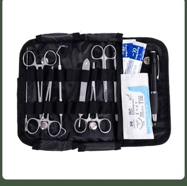 Open black medical kit with scissors, tweezers, bandages, and pen.