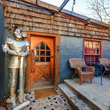 A photo showcasing the entrance to our Camelot Suite, featuring a suit of armor 