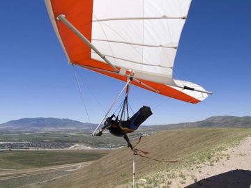 A hang glider pilot swooping in a falcon 4 at Utah's point of the mountain south side flight park