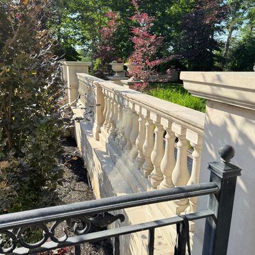 Pressure washing stone balustrade and masonry wall after cleaning