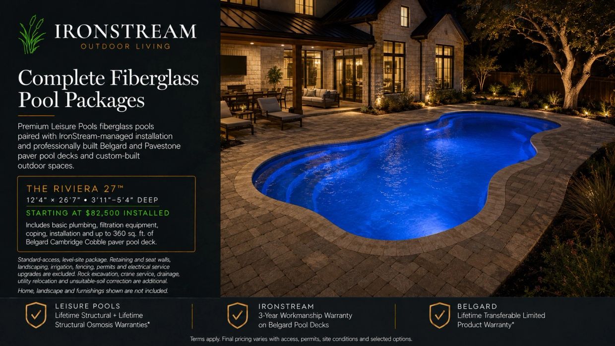Outdoor fiberglass pool with paver deck at night.