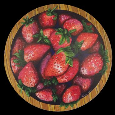 A vibrant bowl filled with ripe strawberries on a wooden surface.