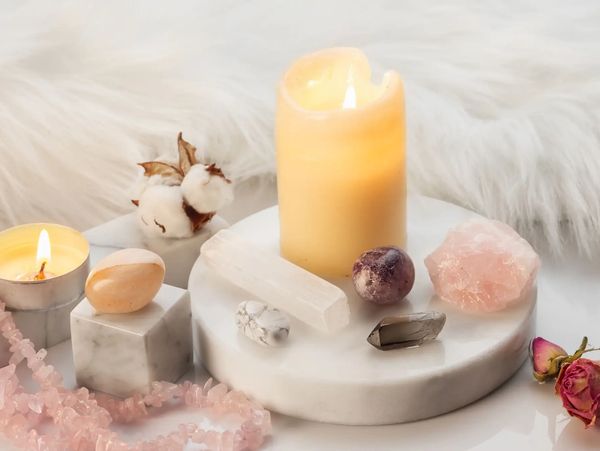 Candles and crystals on a marble tray