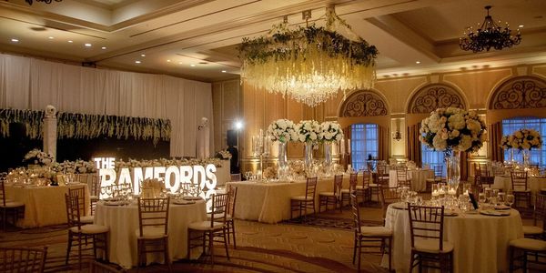 Elegant wedding reception with floral centerpieces and warm lighting.