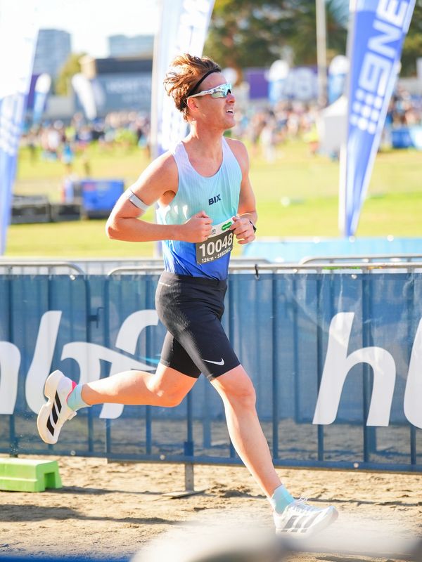 Athlete running in a race wearing sunglasses and race bib 10048.