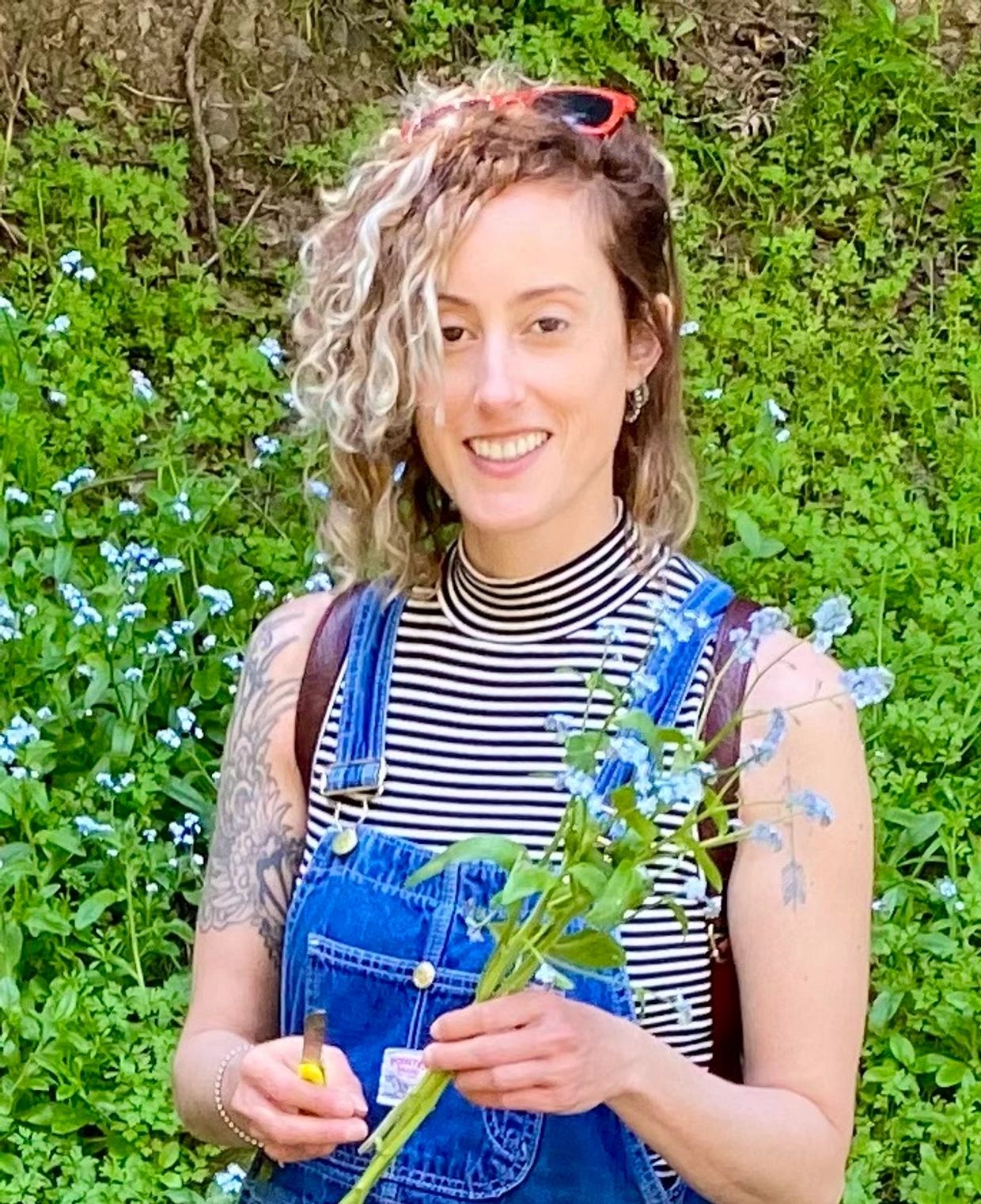 A girl standing holding flowers