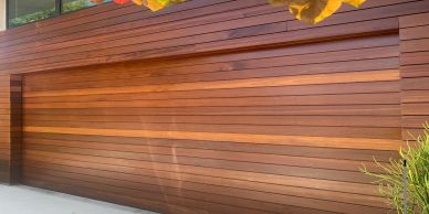 Modern wooden garage door with horizontal panels.