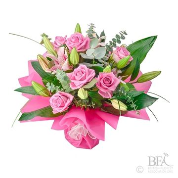 The ever popular fragrant handtied bouquet of 6  Roses & lilies. Aqua pack wrapping.