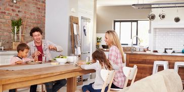 a family of four people enjoying their lunch 