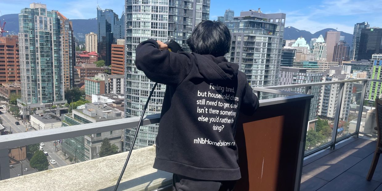Condo Cleaning - Power washing condo balcony in Vancouver, under the hot hot sun