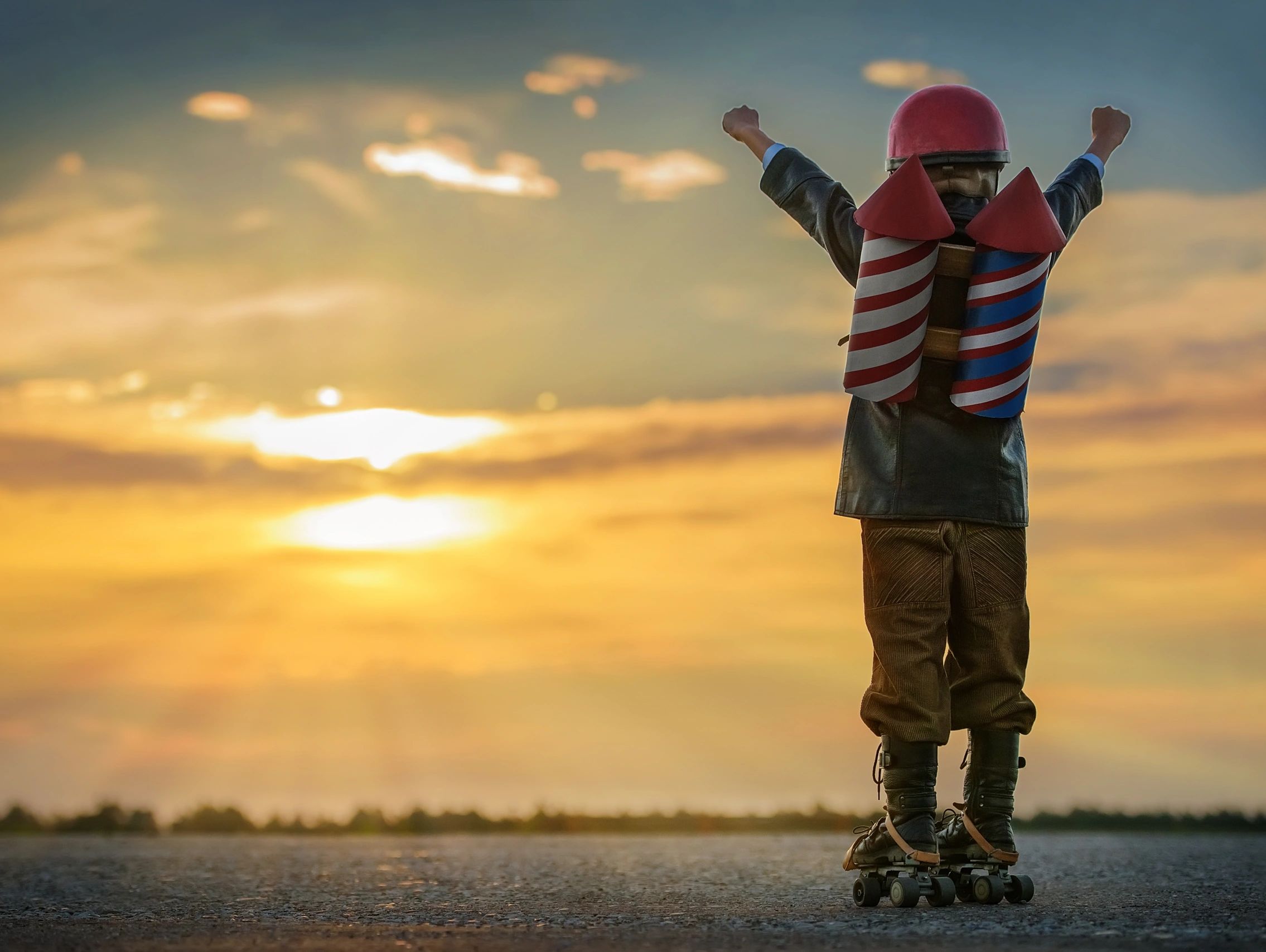 Image of little boy triumphantly holding fists in the air 