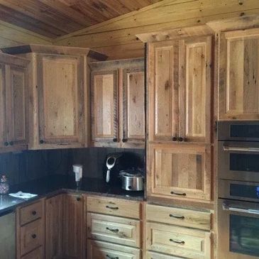 Rustic kitchen with wooden cabinets and modern appliances.
