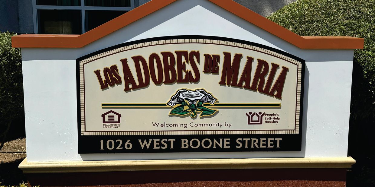 los adobes de maria triangle monument address brown white sign