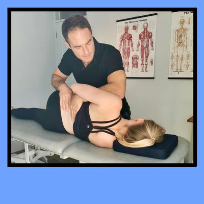 Osteopathic treatment of lower back pain for a lady lying on a plinth in the clinic room