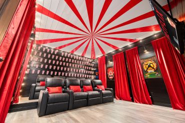 Home theater room with red and black decor.