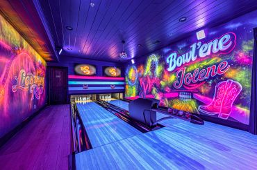 Colorful bowling alley with neon wall art.