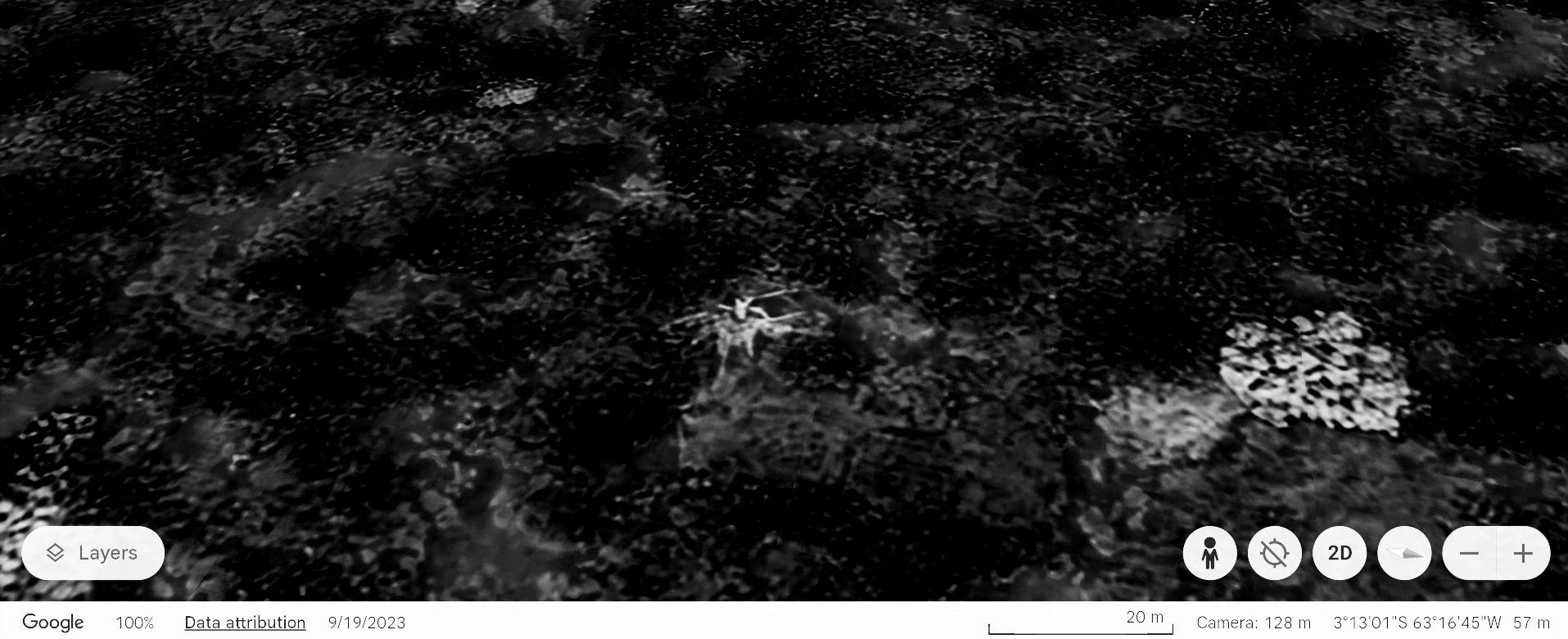 A spider is visible on a dark textured surface.