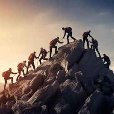 Group climbing a rocky mountain peak at sunrise or sunset.