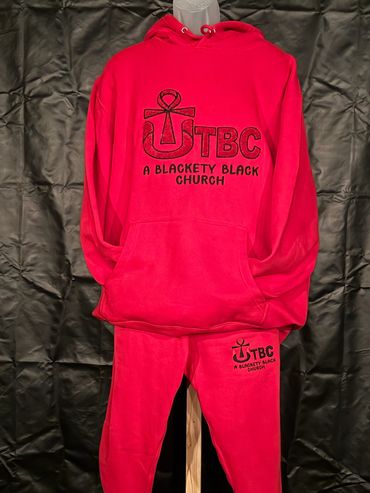 Red hoodie and sweatpants set with TBC logo and "A Blackety Black Church" text.