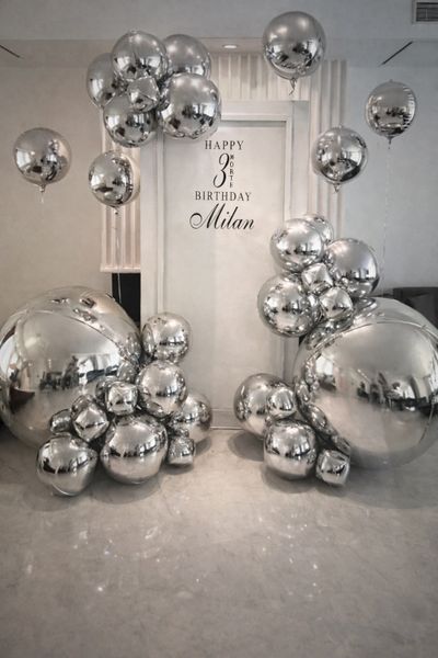 Silver balloons decorate a birthday celebration for Milan's 38th year.