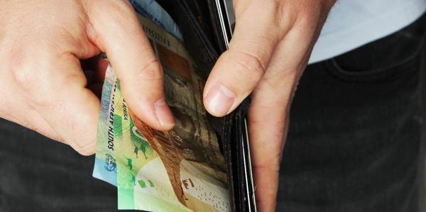 Image of money in a wallet for tipping in St Lucia South Africa