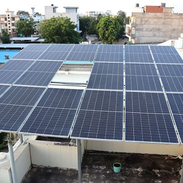 Solar panels installed on a rooftop in an urban area.