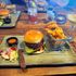 burger and chips with a passion fruit martini on a wooden table 