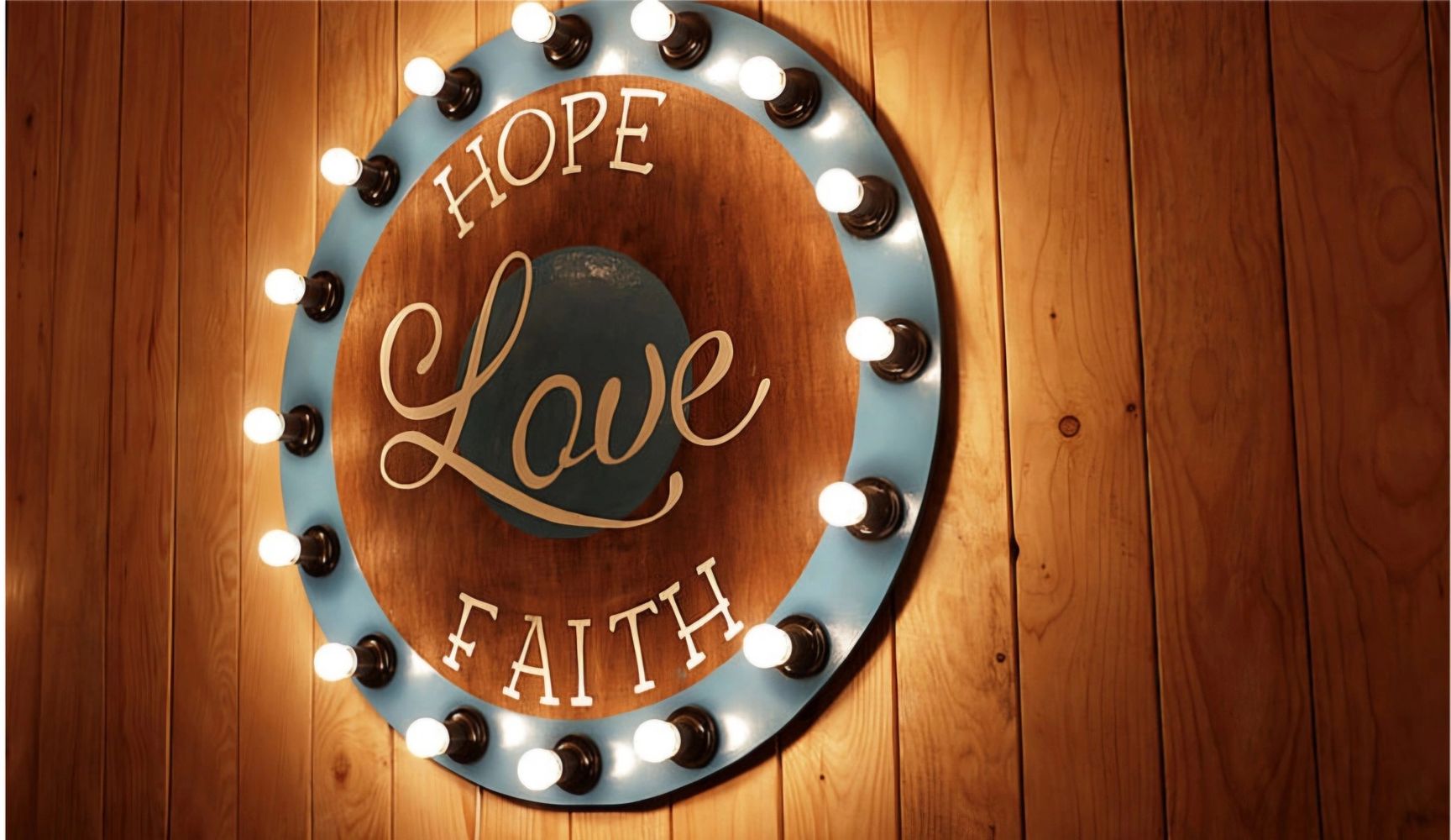 Wooden wall decor with lights and words hope, love, faith.