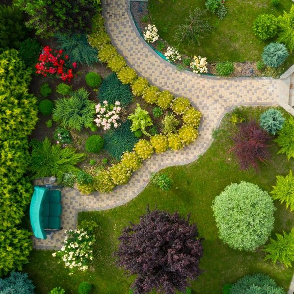 Aerial view of a landscaped garden with pathways and colorful plants.