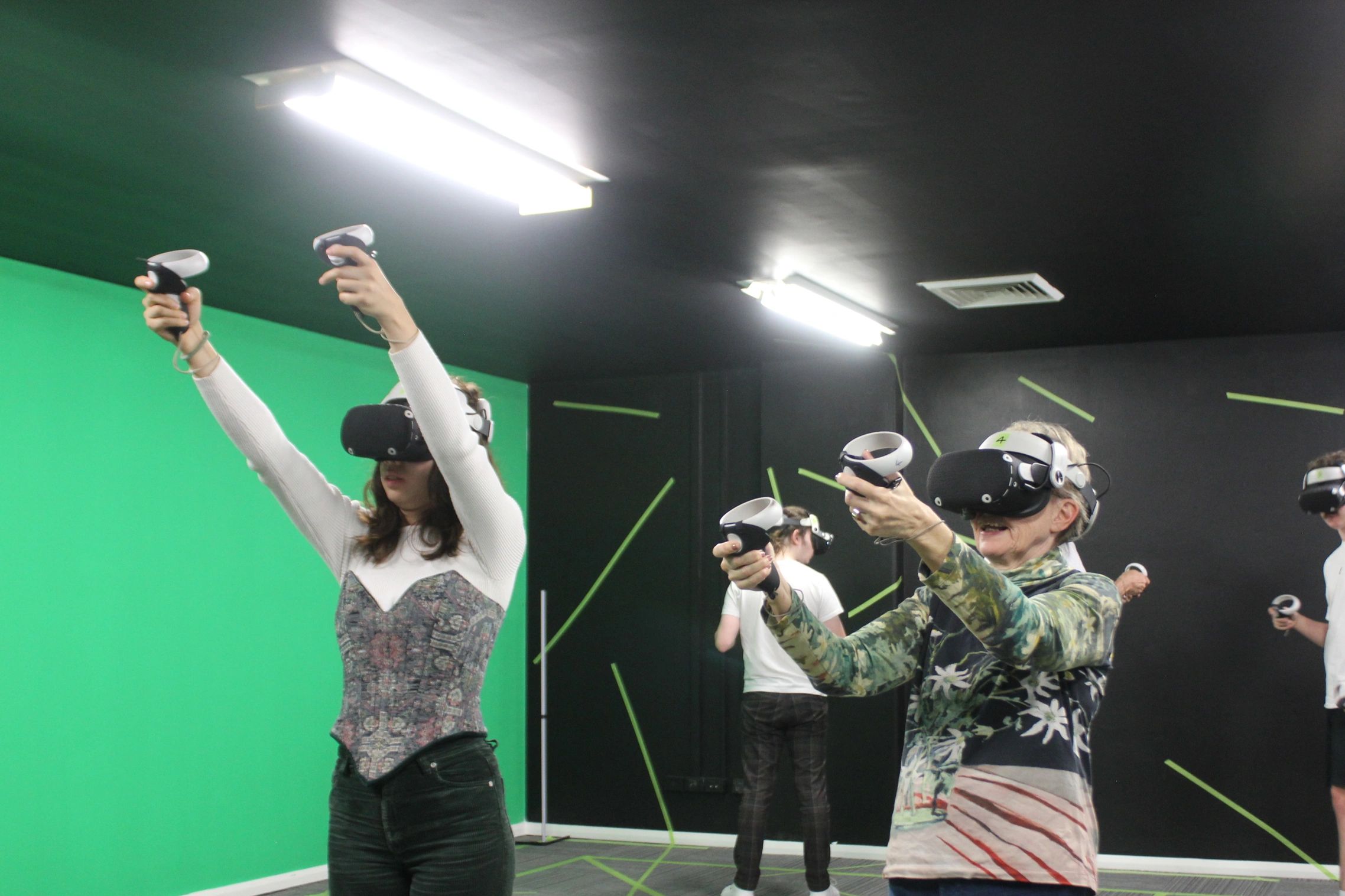 A group of people enjoying a virtual reality experience in a dedicated room.