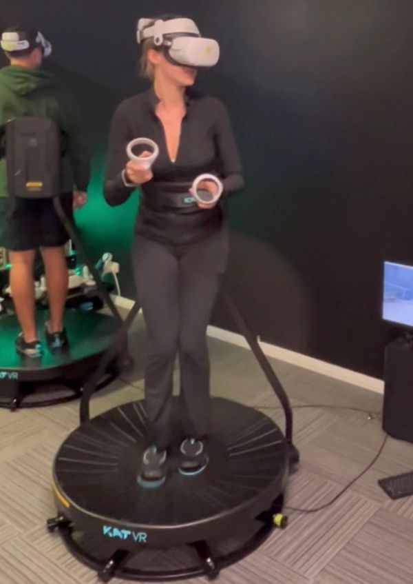 Person exercising on a small round trampoline indoors.