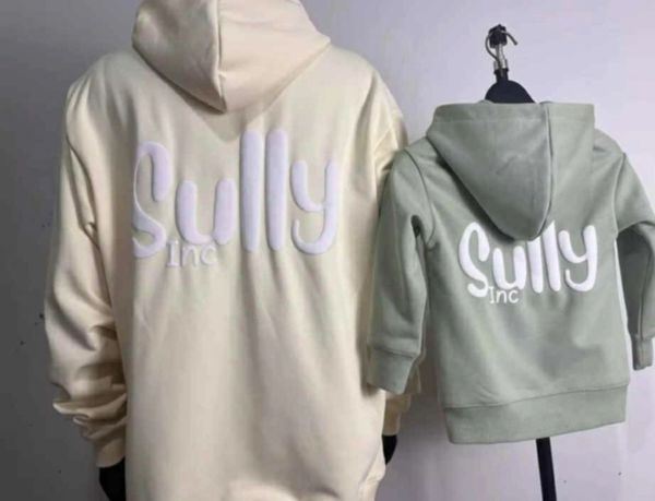 Matching adult and child hoodies with 'Sully Inc' design on the back.