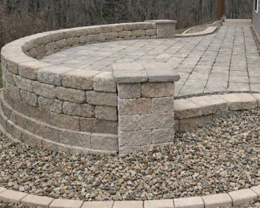 Retaining wall surrounding a functional paver patio