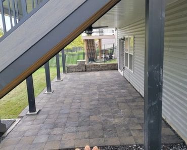 Functional paver patio under a deck
