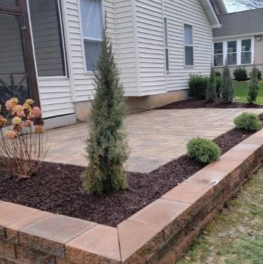 Retaining wall surrounding a functional paver patio
